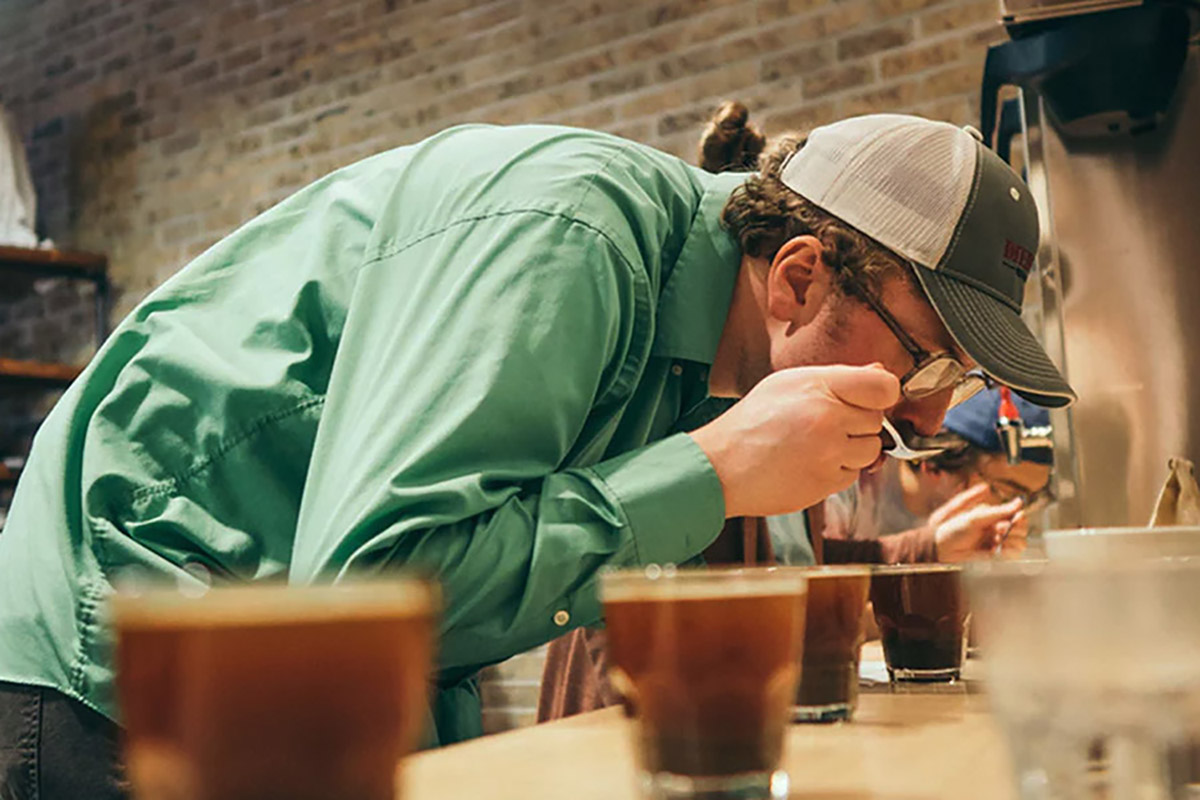 man tasting coffee during cupping event